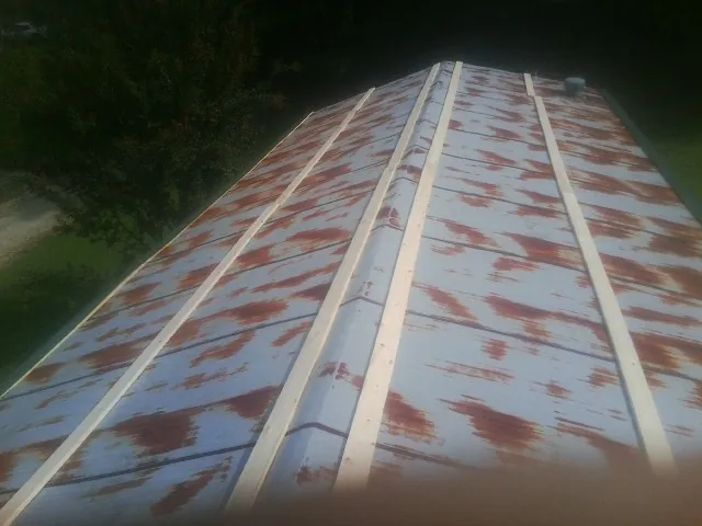 Rusted metal roof panels with new wood purlins before replacement — Storm Damage Roof Repair in Drexel Hill by Roofing Brothers