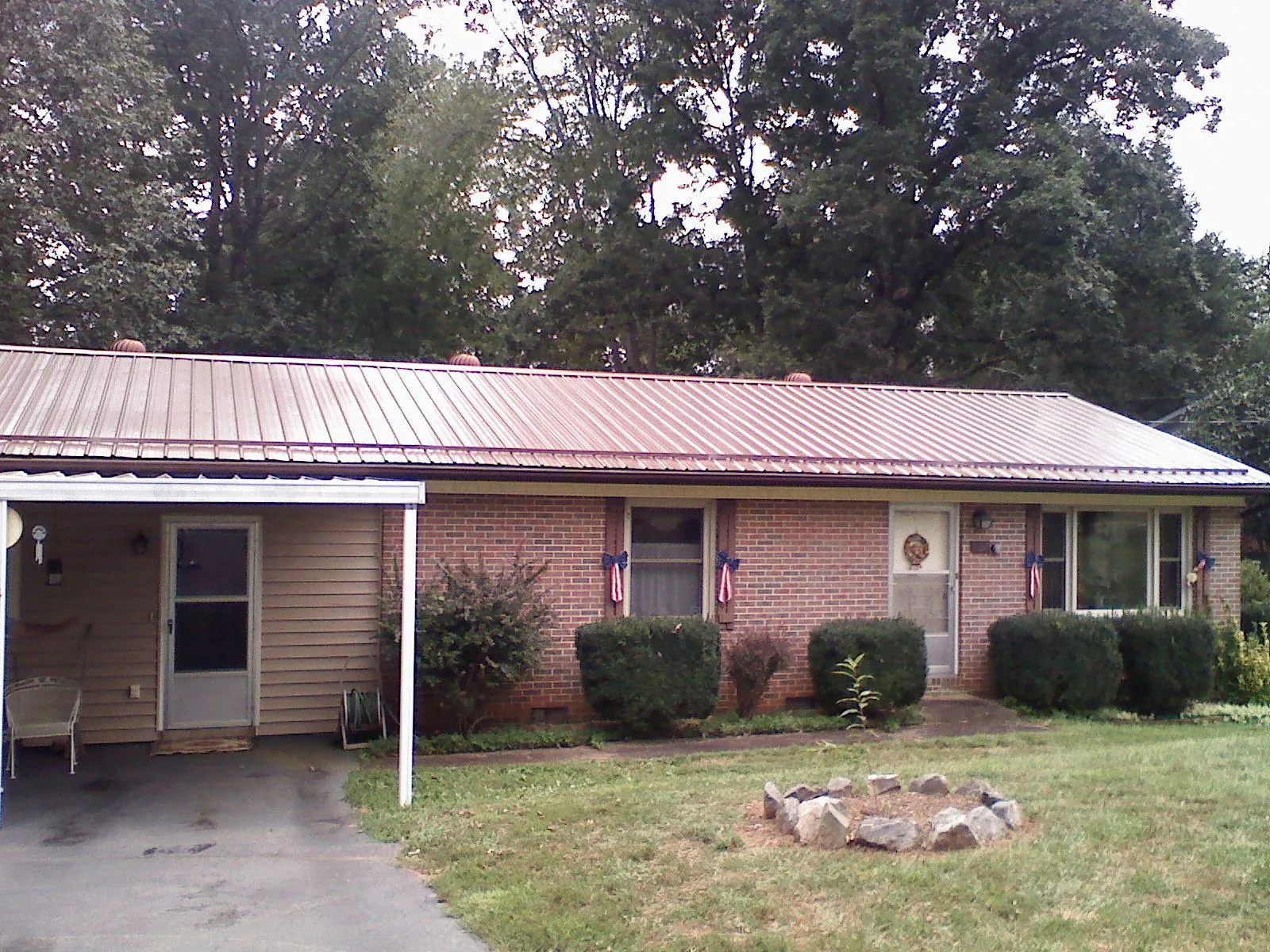 Bronze metal roof and carport on a brick ranch home — Roof Repair work by our crew in Drexel Hill